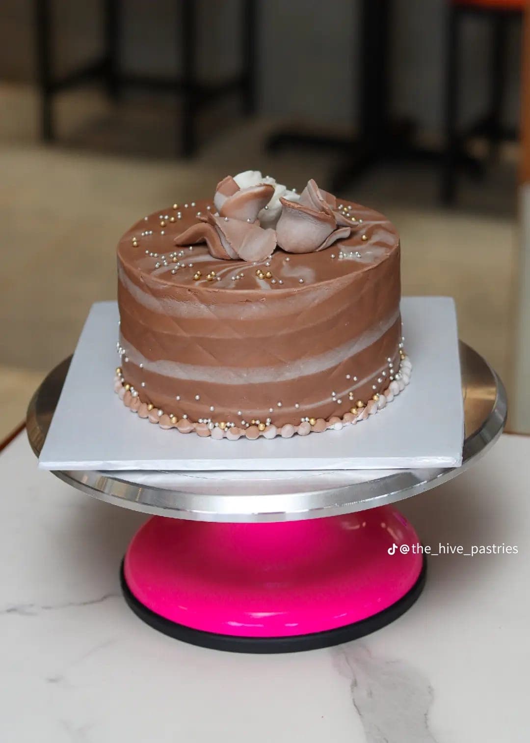 Chocolate swirl cake topped with moulded chocolate roses and sugar pearls