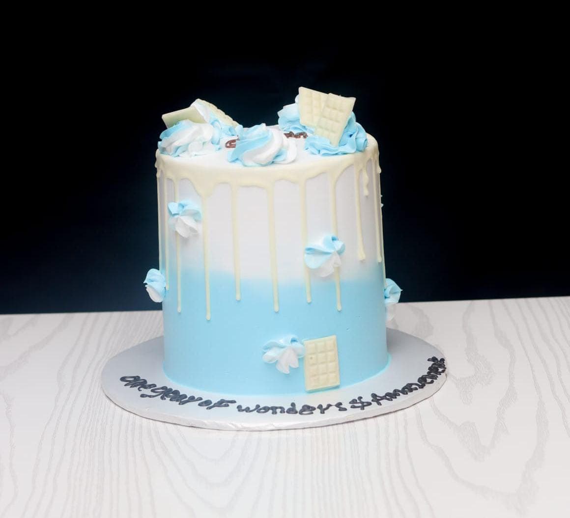 Powder blue ombré cake with white chocolate drip and piped clouds